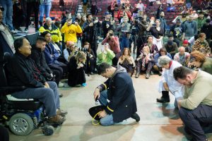 Gen. Wesley Clark Jr., middle, and other veterans kneel in front of Leonard Crow Dog during a forgiveness ceremony at the Four Prairie Knights Casino & Resort on the Standing Rock Sioux Reservation on Monday, Dec. 5, 2016.